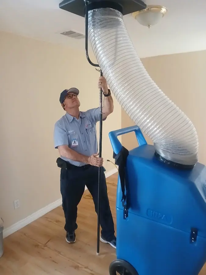 Furnace Tune-Up technician using HEPA equipment in Anoka